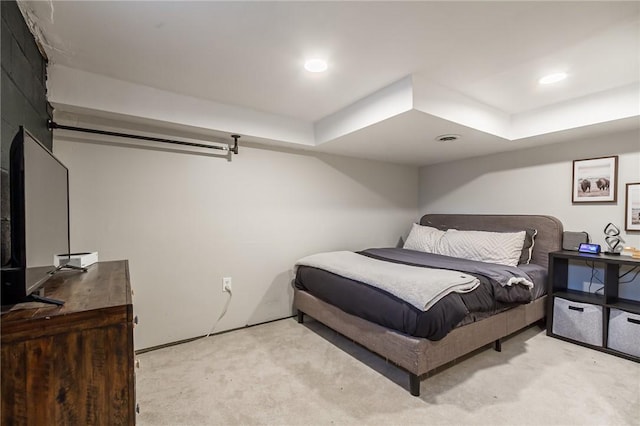 bedroom with light carpet, visible vents, and recessed lighting