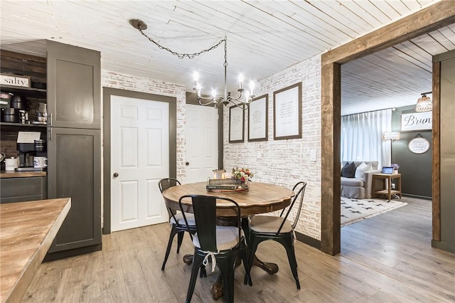 dining space featuring brick wall, an inviting chandelier, wood ceiling, and light wood-style floors