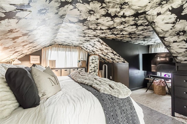 bedroom featuring lofted ceiling and carpet