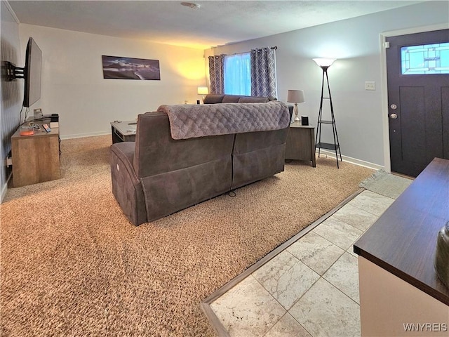 living area featuring carpet flooring and baseboards