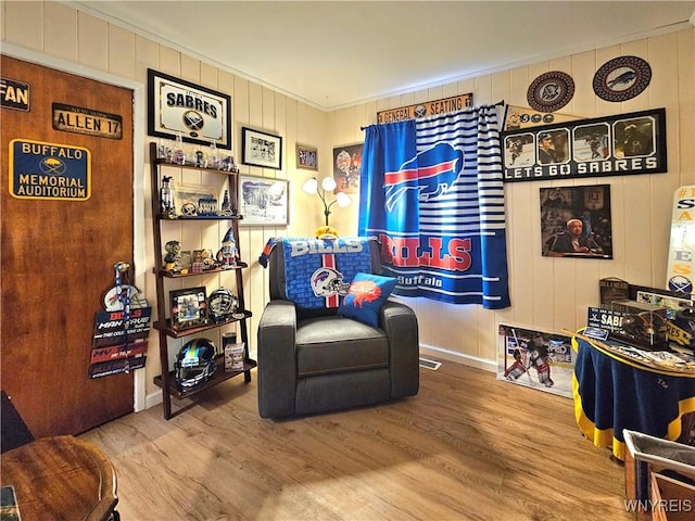 living area featuring ornamental molding, wood finished floors, and visible vents