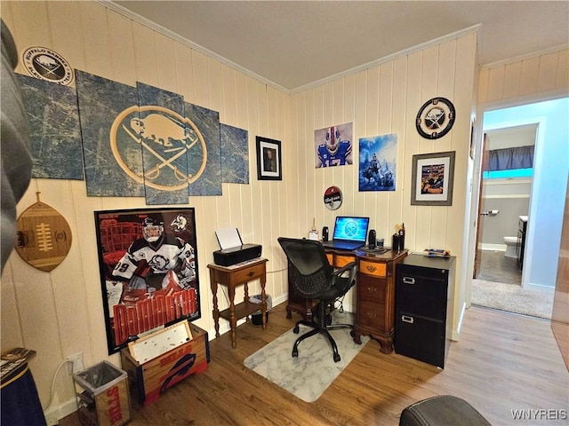 office space with baseboards, wood finished floors, and crown molding