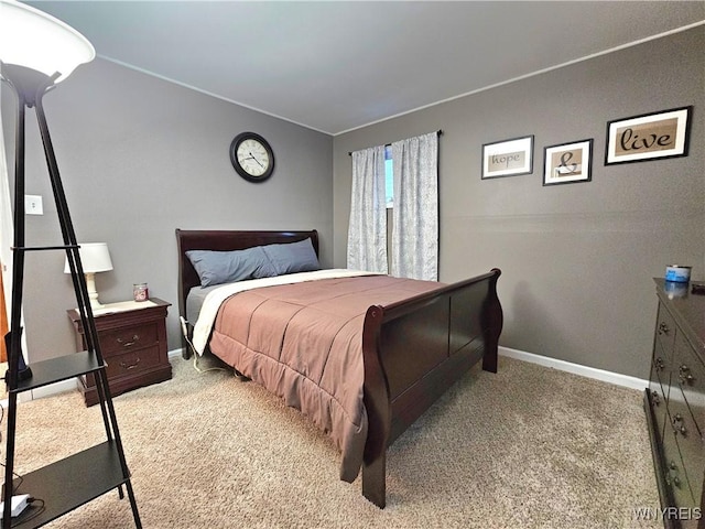 bedroom with baseboards and light colored carpet