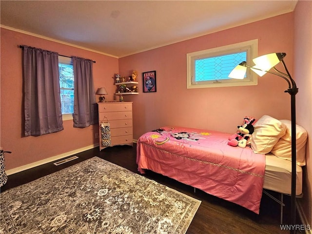 bedroom featuring dark wood-style floors, visible vents, crown molding, and baseboards