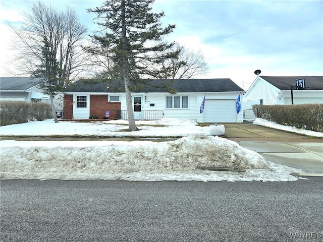 view of front facade with covered porch, driveway, and an attached garage