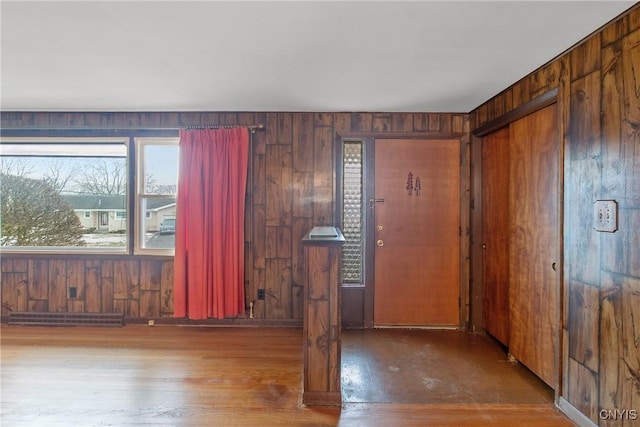 empty room with wood finished floors and wooden walls