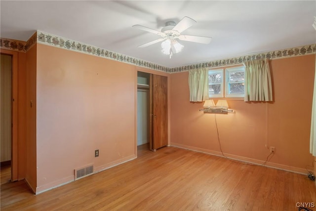 unfurnished bedroom with light wood-style floors, a closet, visible vents, and baseboards