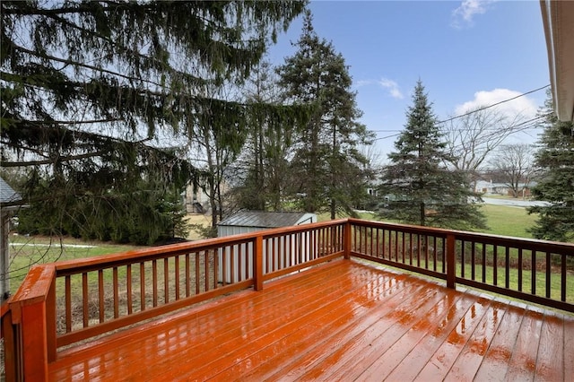 wooden terrace featuring a lawn