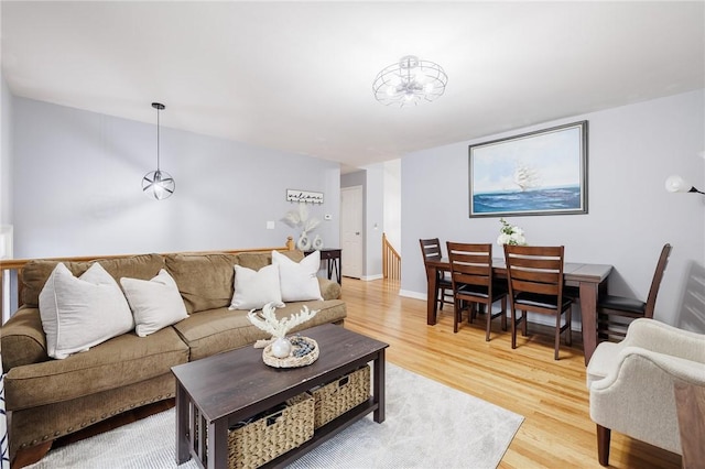 living room featuring light wood-type flooring and baseboards