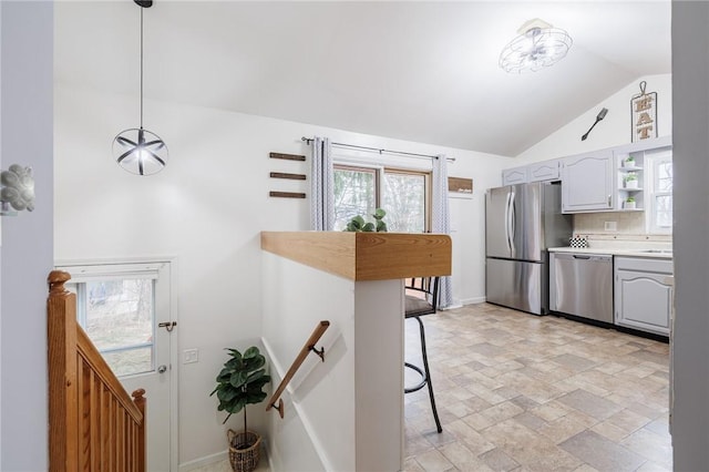 kitchen featuring stainless steel appliances, vaulted ceiling, light countertops, decorative backsplash, and open shelves