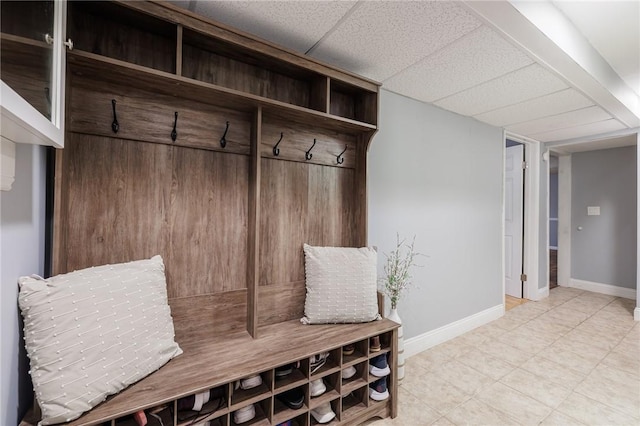 mudroom with a paneled ceiling and baseboards