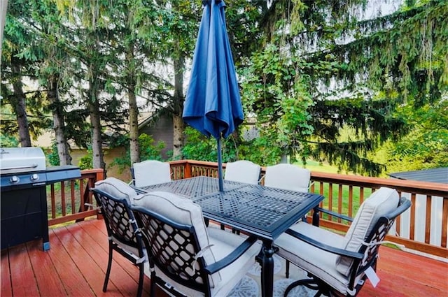 wooden deck featuring outdoor dining space and grilling area