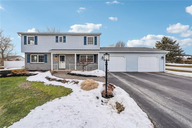 view of front of property with a garage, aphalt driveway, covered porch, fence, and brick siding