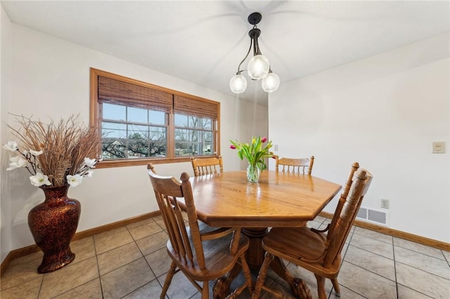 dining area featuring baseboards, visible vents, a notable chandelier, and light tile patterned flooring