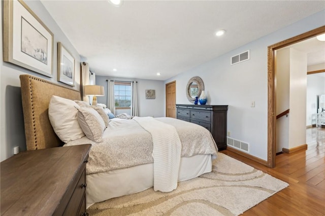 bedroom featuring recessed lighting, wood finished floors, visible vents, and baseboards