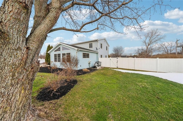 exterior space featuring a gate, a yard, and fence