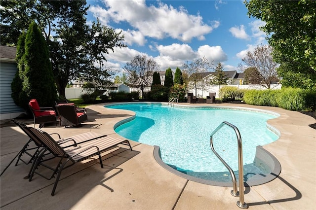 view of pool featuring a patio area, fence, and a fenced in pool