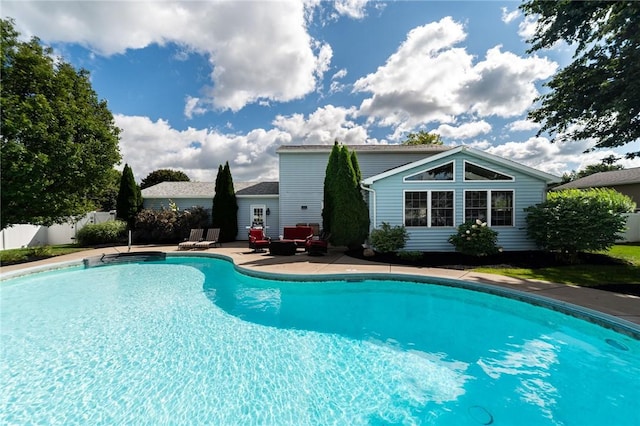 view of swimming pool with a patio area, fence, and a fenced in pool