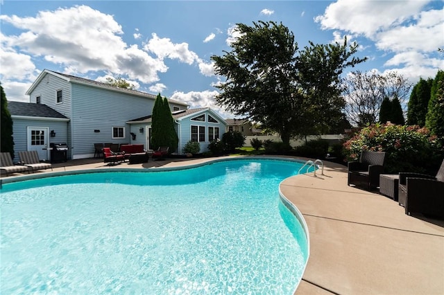 pool featuring outdoor lounge area, area for grilling, and a patio