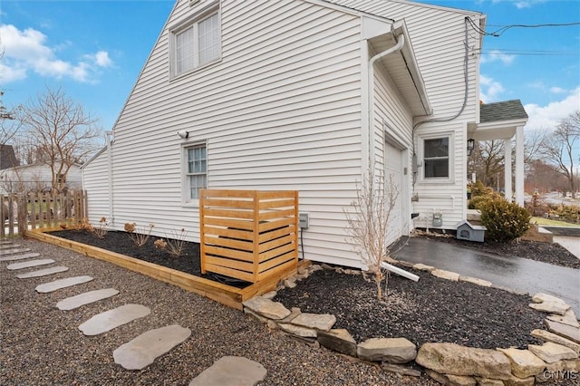 view of property exterior with fence