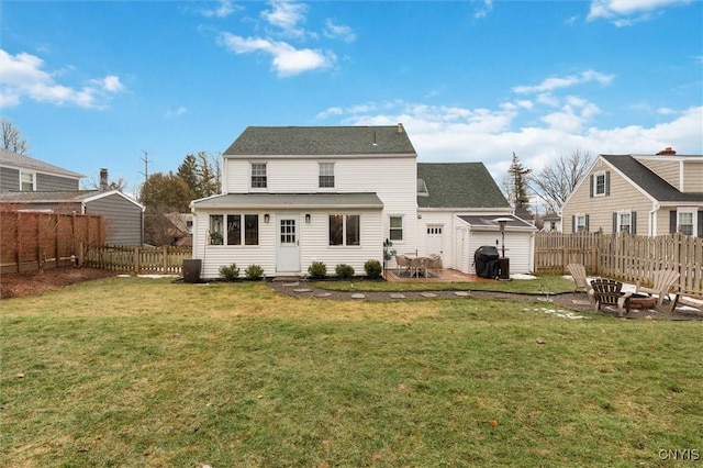 rear view of house featuring an outdoor fire pit, a fenced backyard, a yard, and a patio