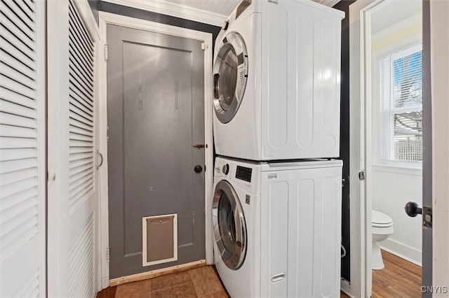 washroom featuring laundry area and stacked washer and clothes dryer