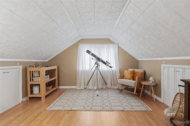 bonus room featuring lofted ceiling, baseboards, and wood finished floors