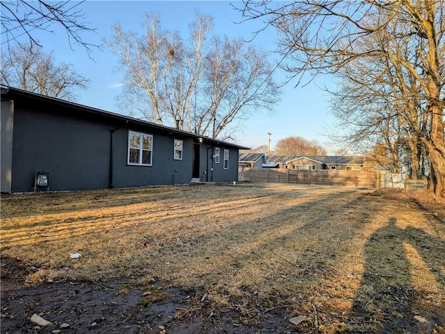 back of property featuring fence