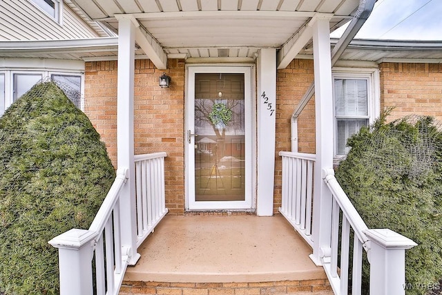 doorway to property with brick siding