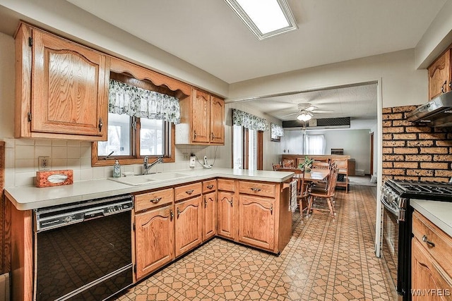 kitchen with a peninsula, a sink, light countertops, dishwasher, and gas range