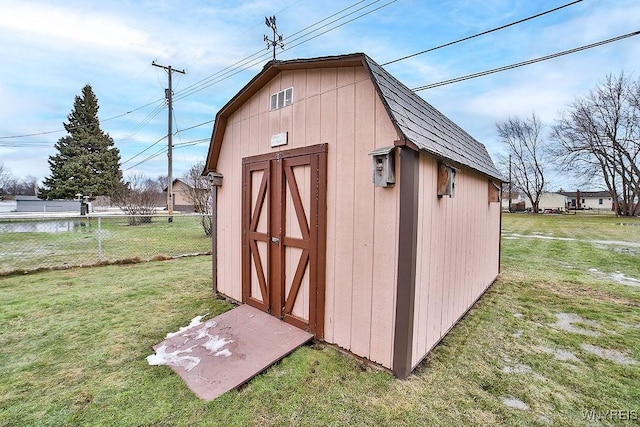 view of shed featuring fence