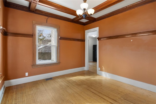 unfurnished room featuring an inviting chandelier, baseboards, coffered ceiling, and wood finished floors