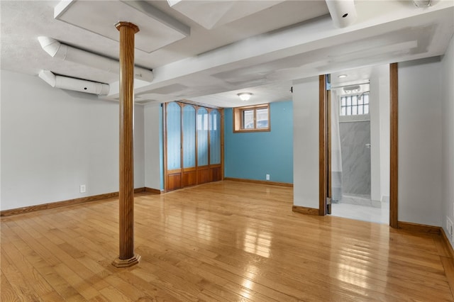 basement featuring hardwood / wood-style flooring and baseboards