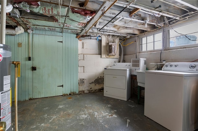 laundry area featuring laundry area, gas water heater, washing machine and clothes dryer, and concrete block wall