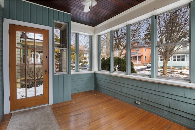 unfurnished sunroom with ceiling fan and wood ceiling