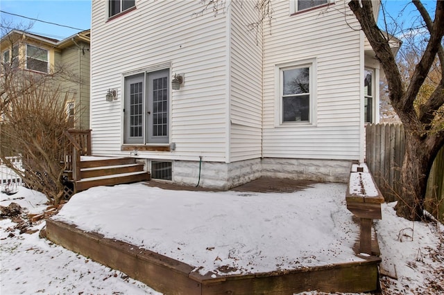 view of snow covered exterior featuring fence