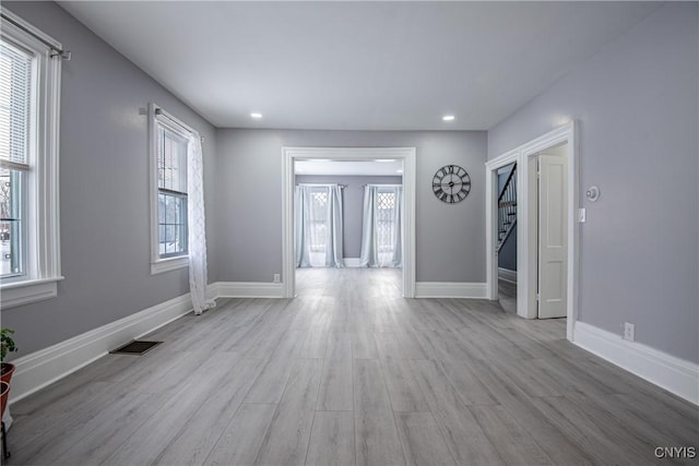 entrance foyer featuring baseboards, visible vents, wood finished floors, and recessed lighting