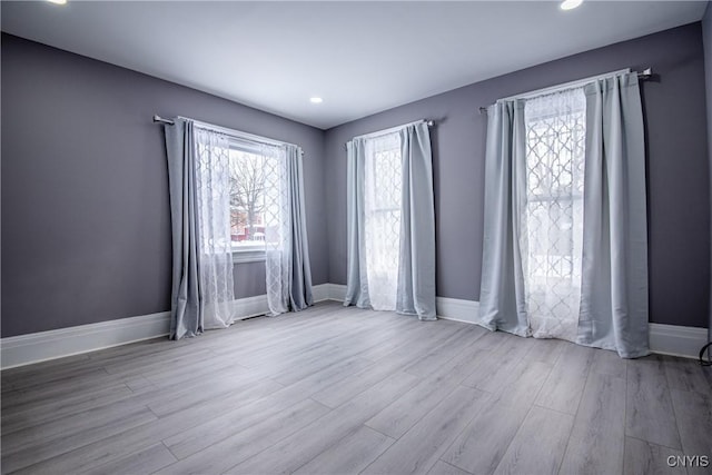 unfurnished room featuring wood finished floors and baseboards