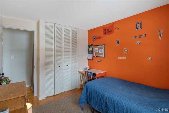 bedroom with a closet and wood finished floors