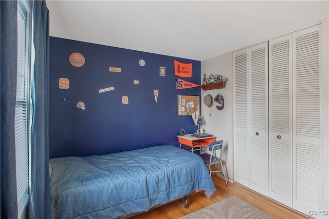 bedroom featuring a closet and wood finished floors