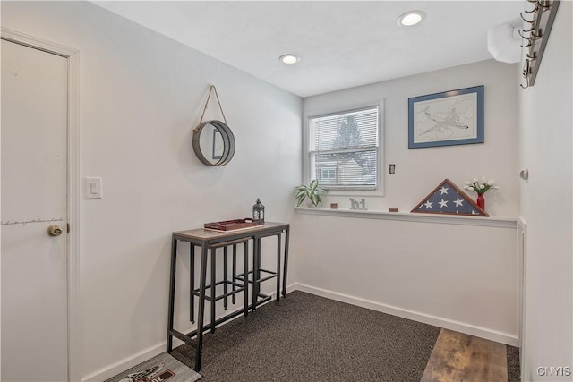 hallway with recessed lighting, dark wood finished floors, and baseboards