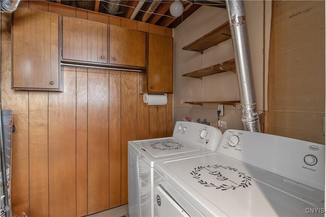 laundry area featuring washer and clothes dryer and cabinet space