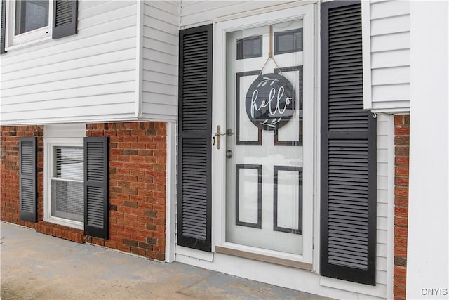 entrance to property with brick siding