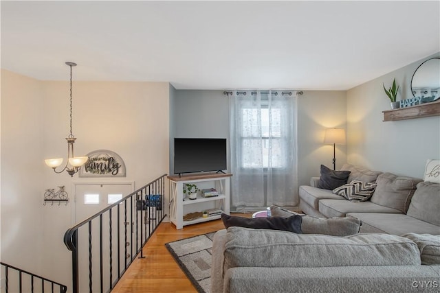 living area with a chandelier and wood finished floors