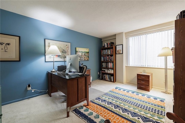 carpeted home office with baseboards