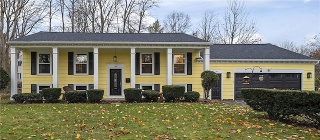 split foyer home featuring a garage and a front lawn