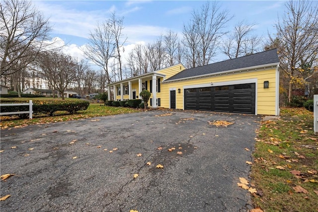 view of front facade featuring aphalt driveway and an attached garage