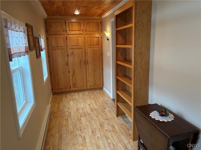 interior space featuring baseboards, wooden ceiling, a baseboard radiator, crown molding, and light wood-style floors