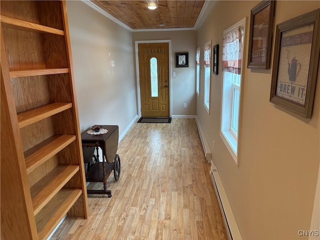 doorway to outside with light wood-type flooring, a baseboard heating unit, baseboards, and ornamental molding