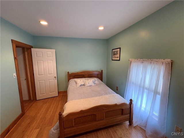 bedroom featuring light wood-type flooring, baseboards, and recessed lighting